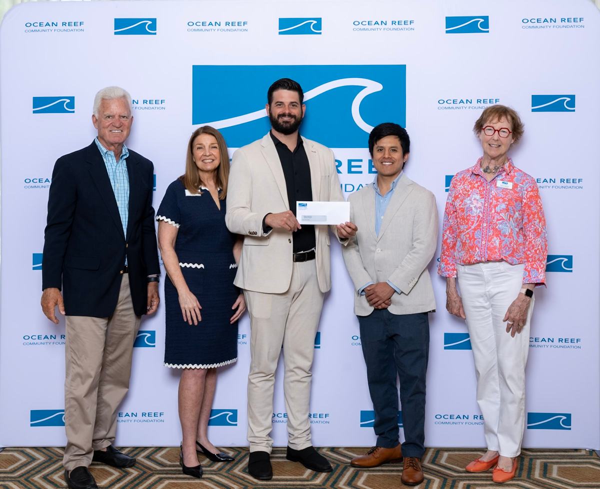 Bridge to Hope_Ocean Reef Community Grants_2026 On behalf of Bridge To Hope, Mr. Lucas Metropulos, accepts a check for $50,000 from the Ocean Reef Community Foundation. He poses with the OCRF Board of Directors to commemorate this honor.